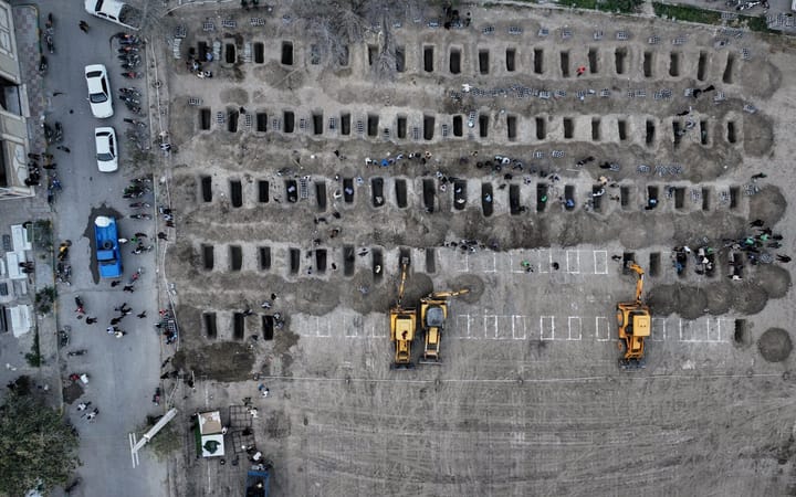 This is an aerial photo showing rows of small graves that were dug for the 150+ children killed by an airstrike on a girls school in Minab, Iran. 